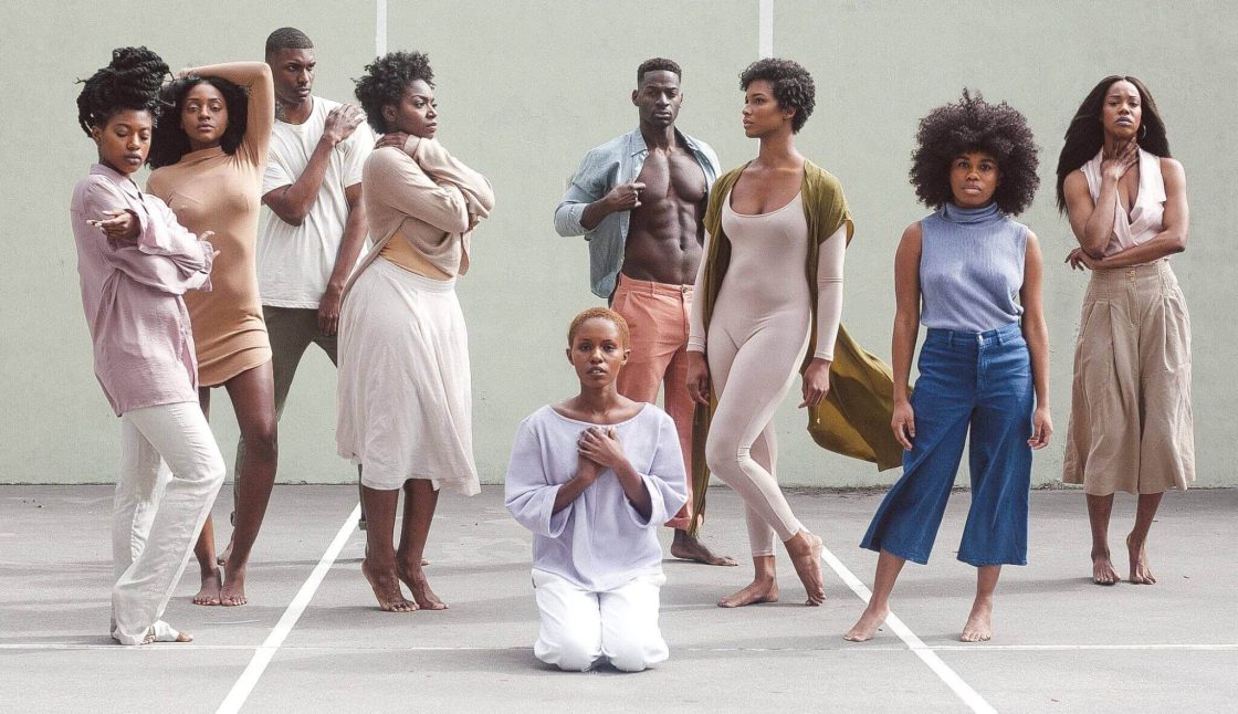 Group of young people standing and kneeling- collaboration