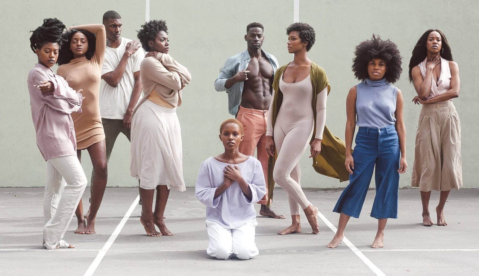 Group of young people standing and kneeling- collaboration