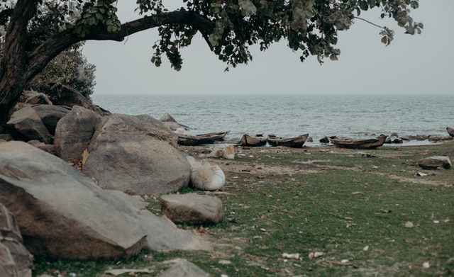 Rocks and canoes by the river side