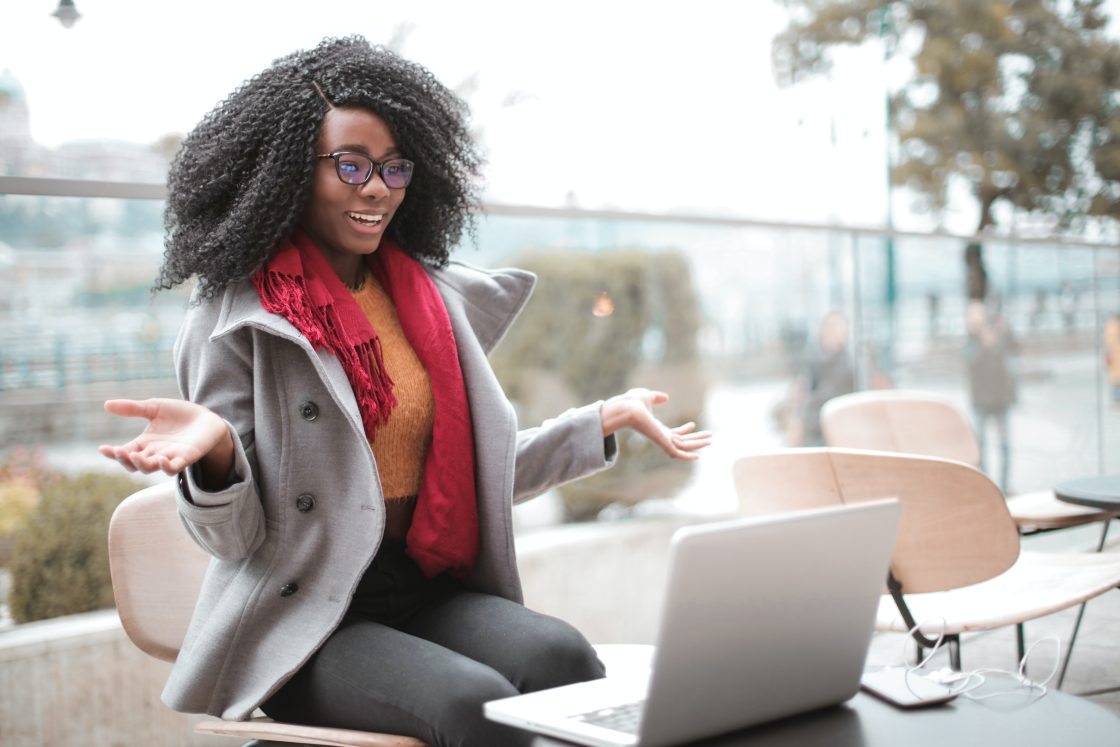 Lady with computer in front - Stock photo