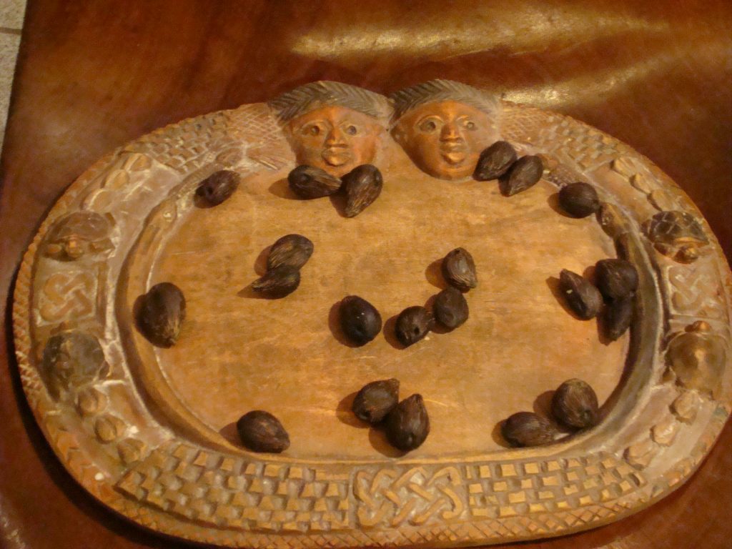 A divination tray (Ọpọ́n Ifá) on which palm nuts rest, as are used for Ifá divination. 